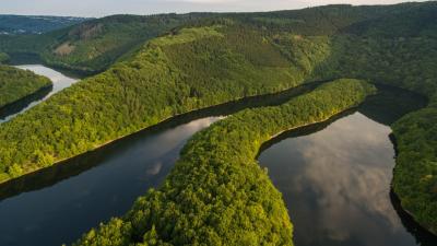 Photograph showing lush land and a winding river from above