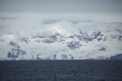 Photograph of icy/snowy land abutting the sea.