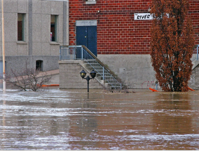 Image of flooding flooded street with water nearly reaching the top of streetlights. 