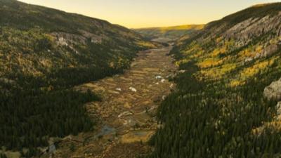 Colorado valley with mountains and river.