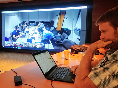 Nathan Collier, a computational earth system scientist at Oak Ridge National Laboratory, evaluates CMIP6 model soil carbon turnover times while researchers at other locations work on their own analyses.