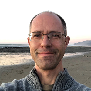 Pacific Northwest National Laboratory scientist Ian Kraucunas on the beach in Lincoln City, Oregon, during an extreme low tide on a rare sunny winter day in early 2021. Photo is courtesy of Ian Kraucunas. 