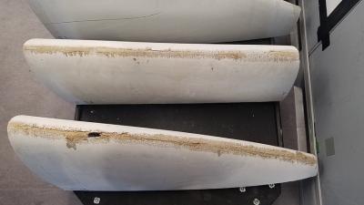 Photograph of material loss from part of a decommissioned wind turbine blade. This damage reflects precipitation-induced leading edge erosion. 