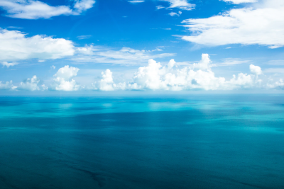 Clouds over bright blue ocean