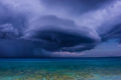 Warmer temperatures cause seasonal tropical precipitation to behave differently over the land and the ocean. 